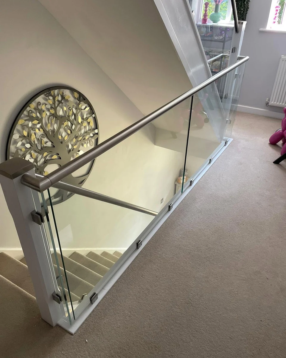 Frameless glass balustrade with steel rail on upper landing, Reigate