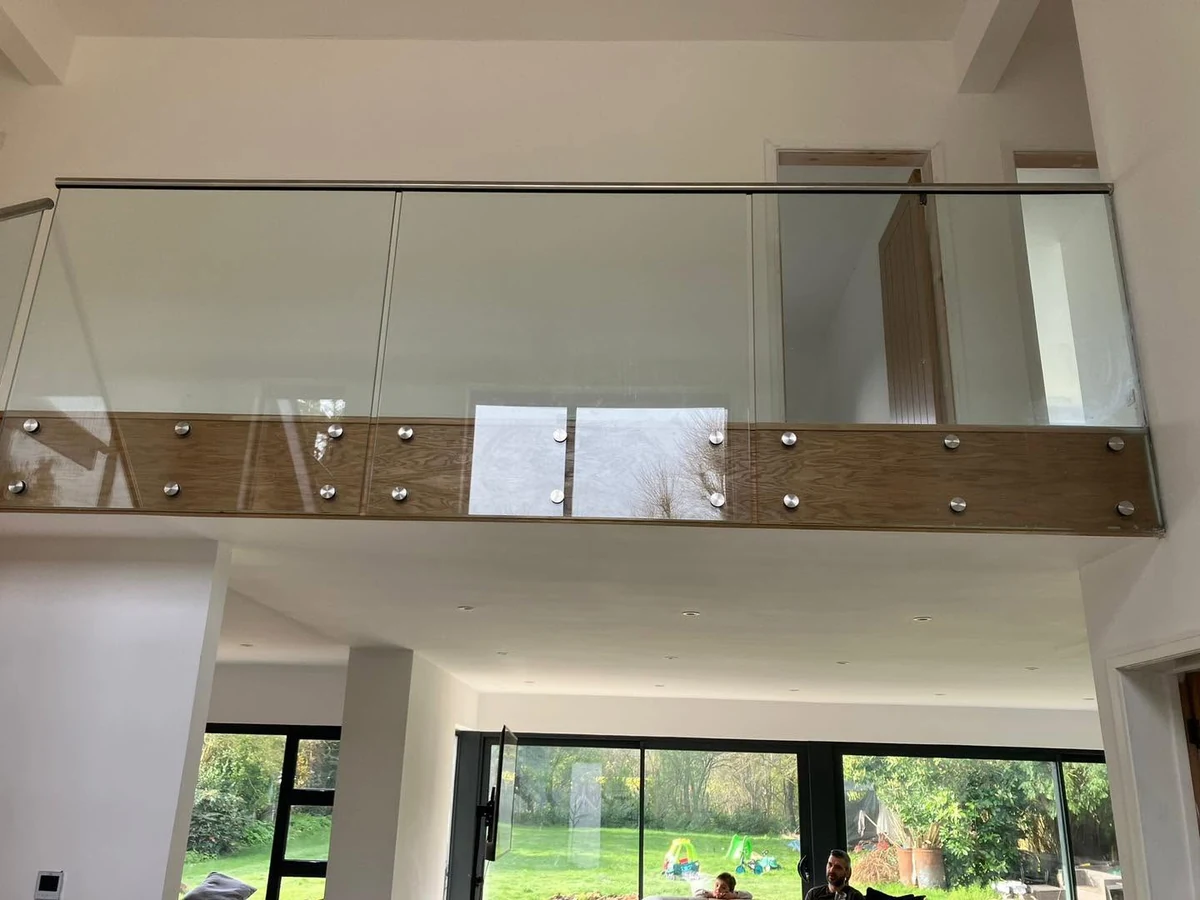 Glass balcony with oak standoff mezzanine installation, Reigate Glass Balustrades