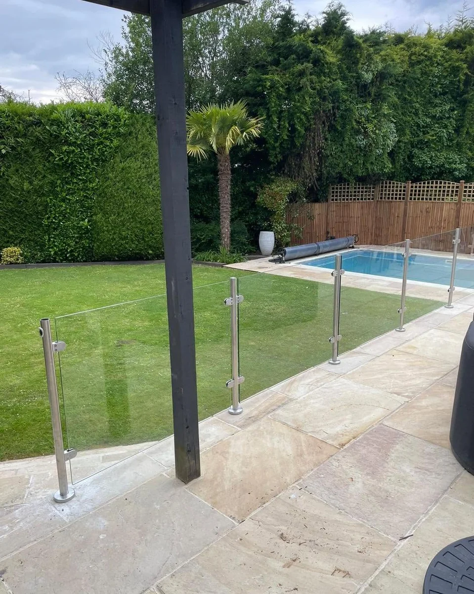 Frameless glass pool fence on sandstone poolside surround, Reigate Glass Balustrades