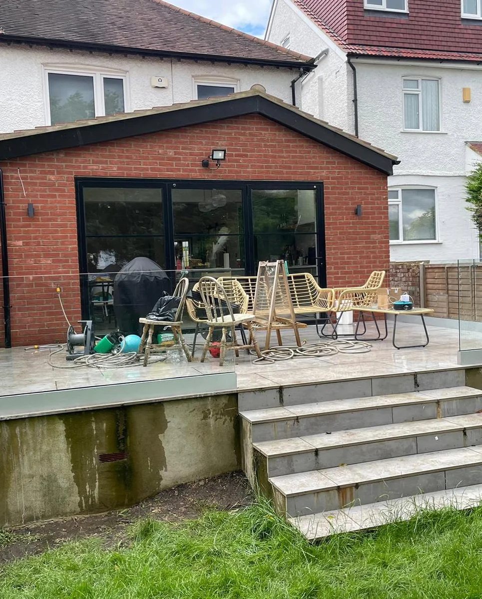 Outdoor glass balustrade patio installation in progress, Reigate