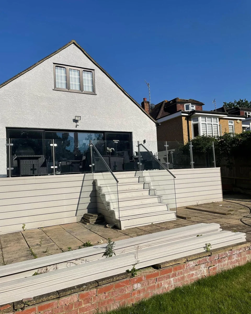 Outdoor glass balustrade on terrace step run adjacent to pool area, Reigate