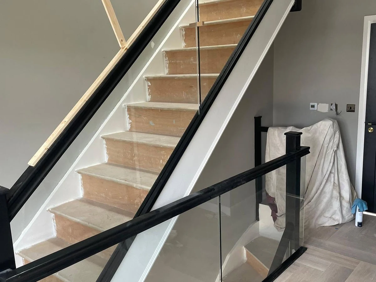 staircase-glass-balustrade-black-frame-herringbone-reigate-reigate-glass-balustrades-hero Glass balustrade staircase with black frame on herringbone floor, Reigate Glass Balustrades