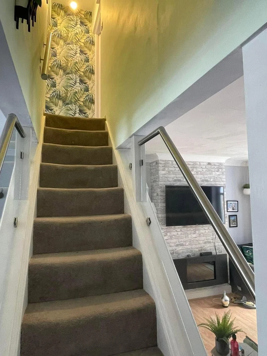 staircase-glass-balustrade-steel-rail-open-plan-reigate-reigate-glass-balustrades Glass balustrade with steel rail in open-plan interior staircase, Reigate