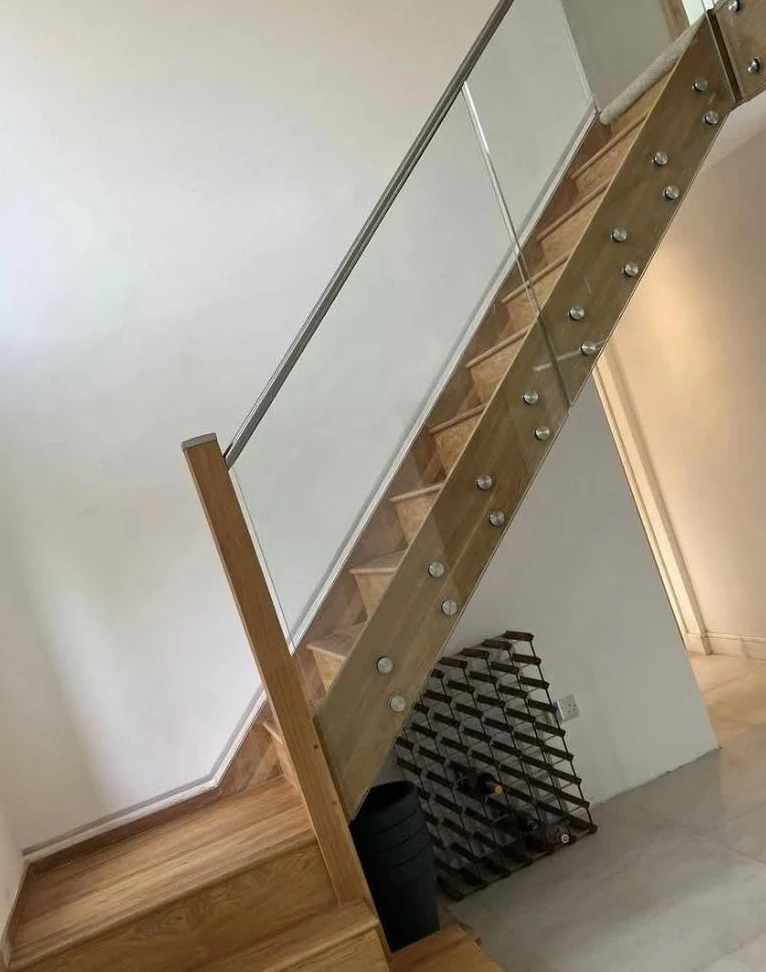 staircase-glass-balustrade-understair-winerack-oak-reigate-reigate-glass-balustrades Glass balustrade with oak elements and under-stair wine rack, Reigate