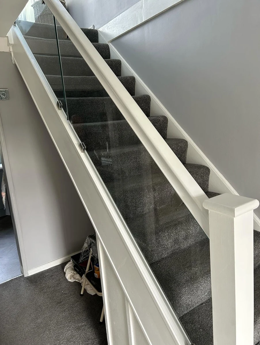 staircase-glass-balustrade-white-rail-understair-reigate-reigate-glass-balustrades Glass balustrade with white rail and under-stair storage, Reigate